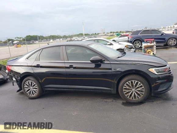 2019 Volkswagen Jetta SEL z VIN 3VWEB7BU2KM273950, wystawiony jako IAAI lot #42414034 z przebiegiem 84 100 mil mil oraz . Historia ofert i sprzedaży dostępna na DreamBid. Obrazek 13.