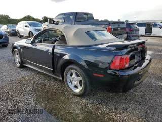 2004 Ford Mustang Deluxe with VIN 1FAFP44414F125267, listed as a Copart auction lot 74595714 with 0 mi miles and Salvage Title. Bid and sale history available at carsss.com. Image 2.