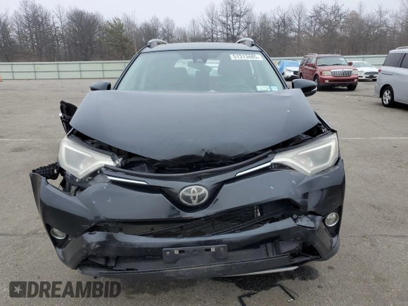 2018 Toyota RAV4 XLE with VIN 2T3RFREV8JW715099, listed as a Copart auction lot 51313485 with 140,107 mi miles and Salvage Title. Bid and sale history available at DreamBid. Image 5.