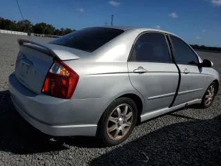 2006 Kia Spectra EX with VIN KNAFE121365229594, listed as a Copart auction lot 77311084 with 129,789 mi miles and Salvage Title. Bid and sale history available at carsss.com. Image 3.