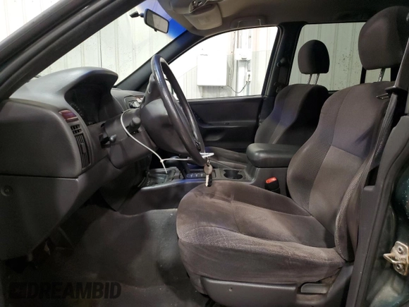 2000 Jeep Grand Cherokee Laredo with VIN 1J4GW48S2YC256123, listed as a Copart auction lot 56015855 with 147,549 mi miles and Salvage title. Bid and sale history available at DreamBid. Image 7.