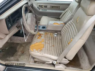 1991 Cadillac Eldorado z VIN 1G6EL13B4MU604636, wystawiony jako Copart lot #79155234 z przebiegiem Nie podano mil oraz Nie do naprawy. Historia ofert i sprzedaży dostępna na DreamBid. Obrazek 7.