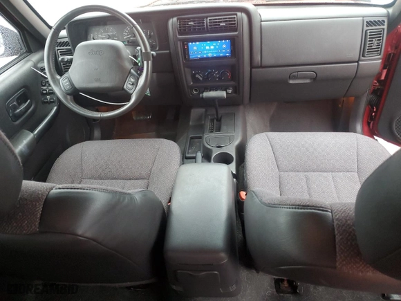 1999 Jeep Cherokee Sport with VIN 1J4FT68S1XL601799, listed as a Copart auction lot 83881844 with 203,572 mi miles and Salvage Title. Bid and sale history available at carsss.com. Image 8.