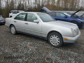 1999 Mercedes-Benz E-Class with VIN WDBJF65H5XA906877, listed as a Copart auction lot 76156014 with 141,956 mi miles and Clean Title. Bid and sale history available at carsss.com. Image 4.