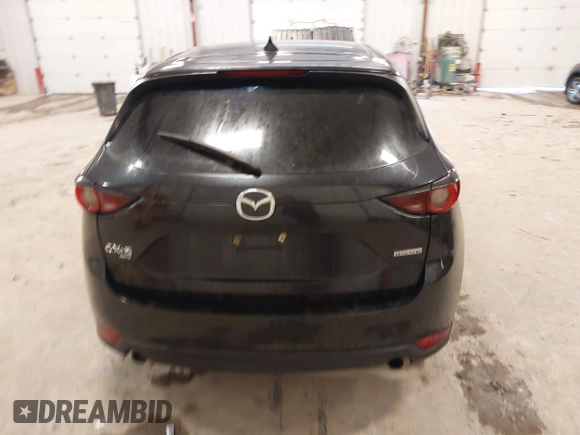 2021 Mazda CX-5 Touring with VIN JM3KFBCM1M1380409, listed as a IAAI auction lot 41677537 with 55,319 mi miles. Bid and sale history available at carsss.com. Image 16.
