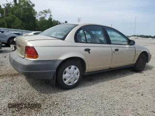 1999 Saturn SL z VIN 1G8ZH5283XZ349797, wystawiony jako Copart lot #58221955 z przebiegiem 148 506 mil mil oraz Nie do naprawy. Historia ofert i sprzedaży dostępna na DreamBid. Obrazek 3.