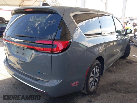 2023 Chrysler Pacifica Hybrid Touring L with VIN 2C4RC1L73PR509853, listed as a IAAI auction lot 41690872 with 83,014 mi miles and . Bid and sale history available at DreamBid. Image 4.