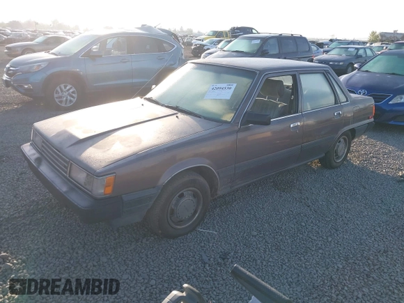 1985 Toyota Camry z VIN JT2SV12EXF0291360, wystawiony jako IAAI lot #42094530 z przebiegiem 426 444 mil mil oraz . Historia ofert i sprzedaży dostępna na DreamBid. Obrazek 2.