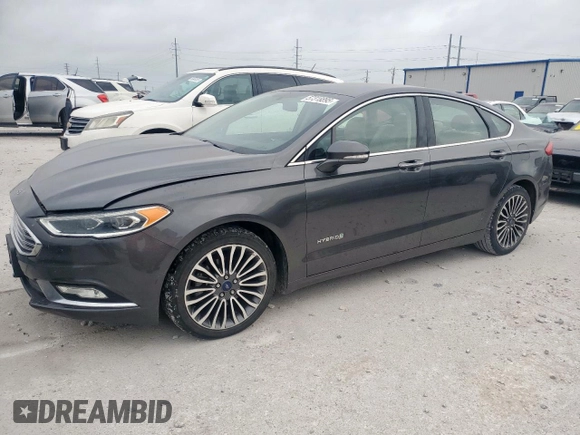 2017 Ford Fusion Hybrid Titanium with VIN 3FA6P0RU7HR388521, listed as a Copart auction lot 57318895 with 117,720 mi miles and Salvage title. Bid and sale history available at DreamBid. Image 1.