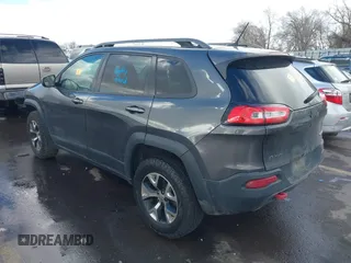 2015 Jeep Cherokee Trailhawk with VIN 1C4PJMBS9FW785545, listed as a IAAI auction lot 41573197 with 124,304 mi miles. Bid and sale history available at carsss.com. Image 3.