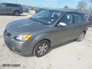2011 Kia Rio LX with VIN KNADH4A39B6923388, listed as a IAAI auction lot 42060176 with 98,690 mi miles. Bid and sale history available at carsss.com. Image 2.