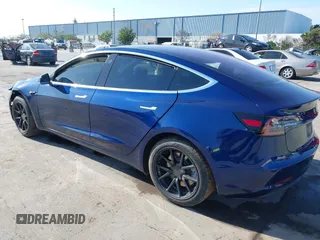 2018 Tesla Model 3 Long Range Battery with VIN 5YJ3E1EA4JF011799, listed as a IAAI auction lot 41765860 with 133,098 mi miles. Bid and sale history available at carsss.com. Image 3.