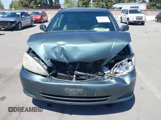 2004 Toyota Camry LE with VIN 4T1BF30K64U067898, listed as a IAAI auction lot 42131958 with 209,702 mi miles. Bid and sale history available at carsss.com. Image 6.