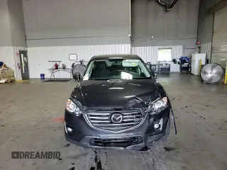 2016 Mazda CX-5 Touring z VIN JM3KE4CY5G0852073, wystawiony jako Copart lot #56599055 z przebiegiem 72 167 mil mil oraz Szkoda całkowita • Salvage title. Historia ofert i sprzedaży dostępna na DreamBid. Obrazek 14.