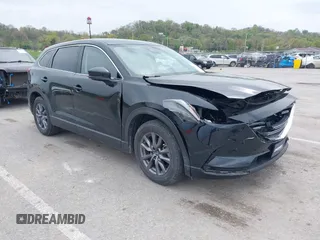 2021 Mazda CX-9 Touring z VIN JM3TCACY3M0506561, wystawiony jako IAAI lot #42051720 z przebiegiem 48 497 mil mil oraz . Historia ofert i sprzedaży dostępna na DreamBid. Obrazek 1.