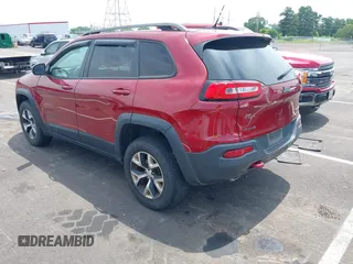 2014 Jeep Cherokee Trailhawk with VIN 1C4PJMBS7EW162357, listed as a IAAI auction lot 42601903 with 104,768 mi miles and . Bid and sale history available at DreamBid. Image 3.