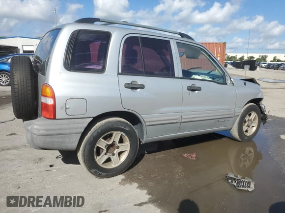 2003 Chevrolet Tracker with VIN 2CNBE13C836953178, listed as a Copart auction lot 60715605 with 128,978 mi miles and Salvage title. Bid and sale history available at DreamBid. Image 3.
