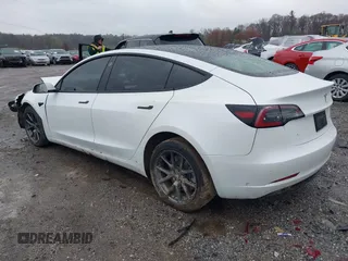 2022 Tesla Model 3 Long Range with VIN 5YJ3E1EB0NF129945, listed as a IAAI auction lot 41965531 with 59,162 mi miles and . Bid and sale history available at DreamBid. Image 3.
