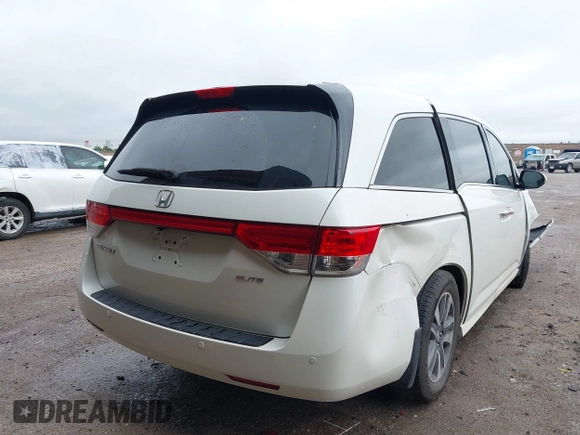 2014 Honda Odyssey Touring with VIN 5FNRL5H95EB059729, listed as a IAAI auction lot 42148110 with 135,304 mi miles and . Bid and sale history available at DreamBid. Image 4.