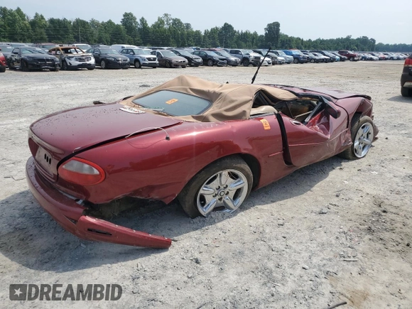 1999 Jaguar XK with VIN SAJGX204XXC038435, listed as a Copart auction lot 64843714 with Not Provided miles and Salvage Title. Bid and sale history available at DreamBid. Image 3.