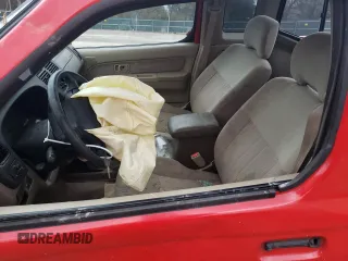 1999 Nissan Frontier XE with VIN 1N6ED26Y4XC313142, listed as a Copart auction lot 85777354 with 122,822 mi miles and Salvage title. Bid and sale history available at DreamBid. Image 7.