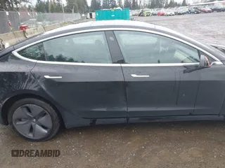 2019 Tesla Model 3 Mid Range with VIN 5YJ3E1EAXKF296378, listed as a IAAI auction lot 41739616 with 77,100 mi miles and . Bid and sale history available at DreamBid. Image 12.