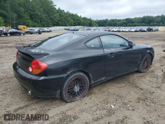 2003 Hyundai Tiburon GT z VIN KMHHN65F83U101784, wystawiony jako Copart lot #41566805 z przebiegiem 99 970 mil mil oraz Nie do naprawy • Non repairable. Historia ofert i sprzedaży dostępna na DreamBid. Obrazek 3.