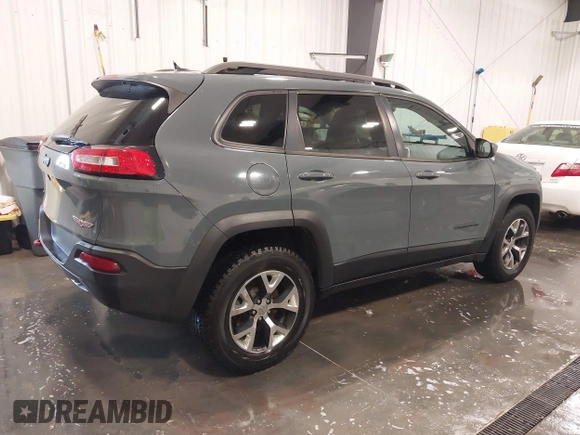 2015 Jeep Cherokee Trailhawk with VIN 1C4PJMBB4FW528633, listed as a IAAI auction lot 42147632 with 166,669 mi miles and . Bid and sale history available at DreamBid. Image 4.