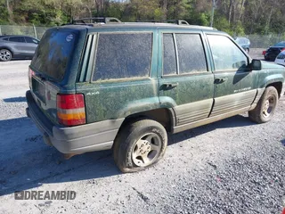 1996 Jeep Grand Cherokee with VIN 1J4EZ58Y7TC128428, listed as a IAAI auction lot 42050443 with 241,591 mi miles and . Bid and sale history available at DreamBid. Image 4.