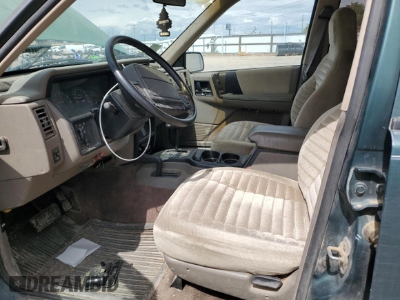 1993 Jeep Grand Cherokee Laredo with VIN 1J4GZ58Y8PC513026, listed as a Copart auction lot 57001465 with 135,242 mi miles and Clean title. Bid and sale history available at DreamBid. Image 7.