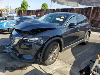 2021 Mazda CX-9 Touring z VIN JM3TCACY1M0518496, wystawiony jako Copart lot #61200765 z przebiegiem Nie podano mil oraz Szkoda całkowita • Salvage title. Historia ofert i sprzedaży dostępna na DreamBid. Obrazek 1.