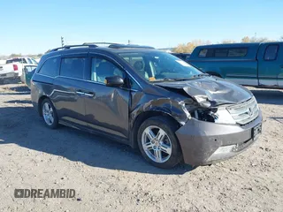 2013 Honda Odyssey Touring with VIN 5FNRL5H9XDB028247, listed as a IAAI auction lot 40635243 with 102,396 mi miles and . Bid and sale history available at DreamBid. Image 1.