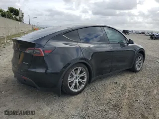 2023 Tesla Model Y Long Range with VIN 7SAYGAEE5PF880779, listed as a Copart auction lot 50777585 with 22,135 mi miles and Salvage Title. Bid and sale history available at carsss.com. Image 3.