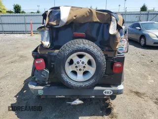 2002 Jeep Wrangler Sport with VIN 1J4FA49S02P721457, listed as a Copart auction lot 61726855 with 76,191 mi miles and Salvage title. Bid and sale history available at DreamBid. Image 6.