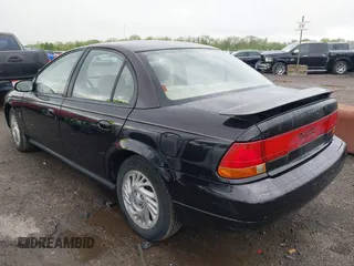 1999 Saturn SL with VIN 1G8ZK5272XZ263163, listed as a IAAI auction lot 42180002 with 138,463 mi miles. Bid and sale history available at carsss.com. Image 3.
