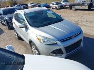 2014 Ford Escape Titanium with VIN 1FMCU0JX7EUC59643, listed as a IAAI auction lot 41082952 with 143,899 mi miles. Bid and sale history available at carsss.com. Image 1.