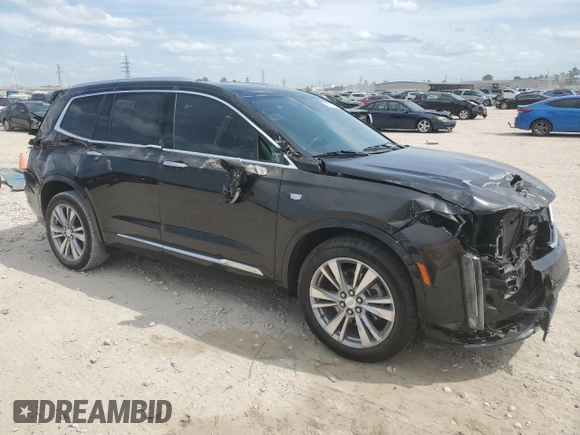 2023 Cadillac XT6 FWD Premium Luxury with VIN 1GYKPCRS6PZ127331, listed as a Copart auction lot 52951105 with 47,796 mi miles and Salvage Title. Bid and sale history available at carsss.com. Image 4.