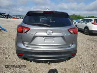 2014 Mazda CX-5 Touring z VIN JM3KE2CY0E0412733, wystawiony jako Copart lot #55803865 z przebiegiem 161 539 mil mil oraz Szkoda całkowita • Salvage title. Historia ofert i sprzedaży dostępna na DreamBid. Obrazek 6.
