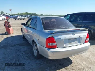 2000 Mazda Protege ES with VIN JM1BJ2213Y0284890, listed as a IAAI auction lot 42088671 with 215,104 mi miles and . Bid and sale history available at DreamBid. Image 3.