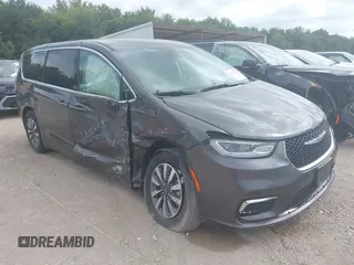2023 Chrysler Pacifica Hybrid Touring L with VIN 2C4RC1L75PR554535, listed as a IAAI auction lot 42592960 with 56,694 mi miles and . Bid and sale history available at DreamBid. Image 1.