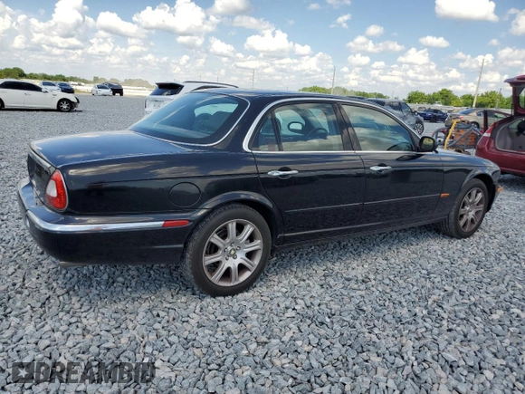 2004 Jaguar XJ with VIN SAJEA71C14SG10928, listed as a Copart auction lot 51202785 with 164,300 mi miles and Salvage Title. Bid and sale history available at carsss.com. Image 3.