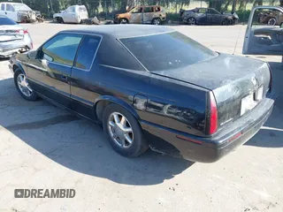 2001 Cadillac Eldorado Touring ETC z VIN 1G6ET12911B103774, wystawiony jako IAAI lot #41998828 z przebiegiem 128 724 mil mil oraz . Historia ofert i sprzedaży dostępna na DreamBid. Obrazek 3.