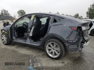 2024 Tesla Model Y with VIN 7SAYGDED5RF093410, listed as a Copart auction lot 50557225 with 6,396 mi miles and Salvage Title. Bid and sale history available at DreamBid. Image 2.