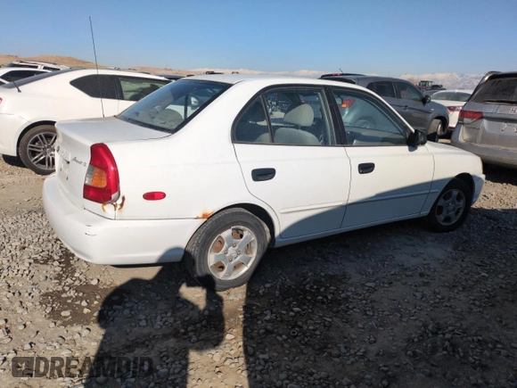 2000 Hyundai Accent z VIN KMHCG45G0YU084004, wystawiony jako Copart lot #42980585 z przebiegiem 167 545 mil mil oraz Czysty tytuł • Clean title. Historia ofert i sprzedaży dostępna na DreamBid. Obrazek 3.