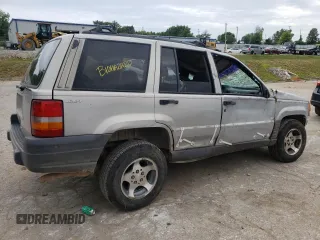1996 Jeep Grand Cherokee Laredo with VIN 1J4GZ58S2TC401845, listed as a Copart auction lot 61013044 with 0 mi miles and Salvage Title. Bid and sale history available at carsss.com. Image 3.