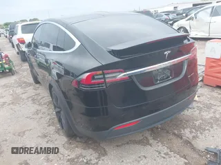 2021 Tesla Model X Long Range Plus with VIN 5YJXCAE27MF324270, listed as a IAAI auction lot 41886101 with 59,614 mi miles and . Bid and sale history available at carsss.com. Image 3.