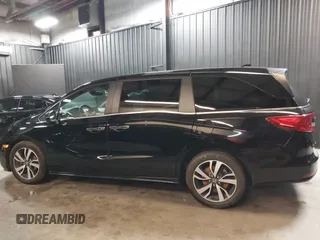 2021 Honda Odyssey Touring with VIN 5FNRL6H83MB040138, listed as a IAAI auction lot 39150096 with 61,322 mi miles and . Bid and sale history available at DreamBid. Image 14.
