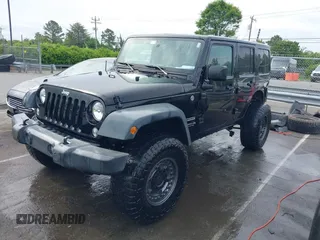 2015 Jeep Wrangler Unlimited Willys Wheeler with VIN 1C4BJWDG4FL687829, listed as a IAAI auction lot 42099147 with 98,969 mi miles and . Bid and sale history available at DreamBid. Image 2.