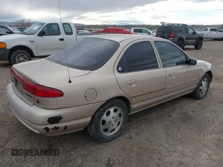 1999 Mercury Mystique GS z VIN 1MEFM6538XK606647, wystawiony jako IAAI lot #41613999 z przebiegiem 90 978 mil mil oraz . Historia ofert i sprzedaży dostępna na DreamBid. Obrazek 4.
