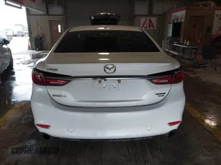 2021 Mazda 6 Carbon Edition with VIN JM1GL1WY9M1614117, listed as a IAAI auction lot 41305576 with 54,670 mi miles and . Bid and sale history available at DreamBid. Image 16.